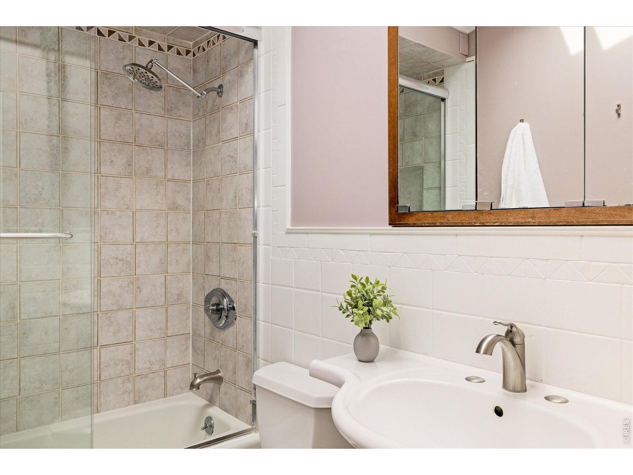 9234 Arapahoe Road Boulder, CO 80303 - Photo 22 of 37 full bathroom featuring a tiled shower surround, glass enclosure, and comfortable heated flooring