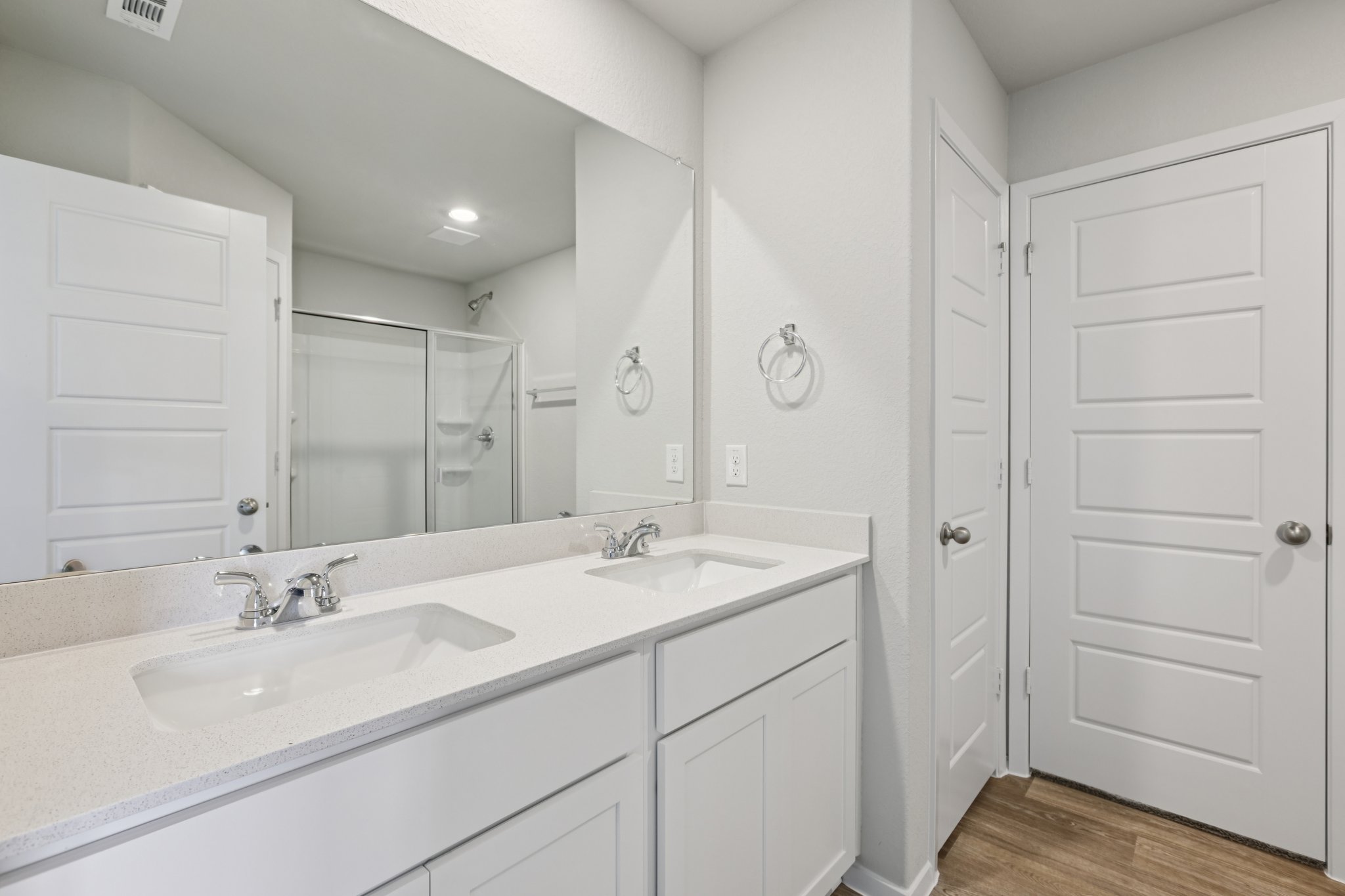 297 Jade Street Maxwell, TX 78656 - Photo 20 of 40 a bathroom with a double vanity sink a mirror and a shower