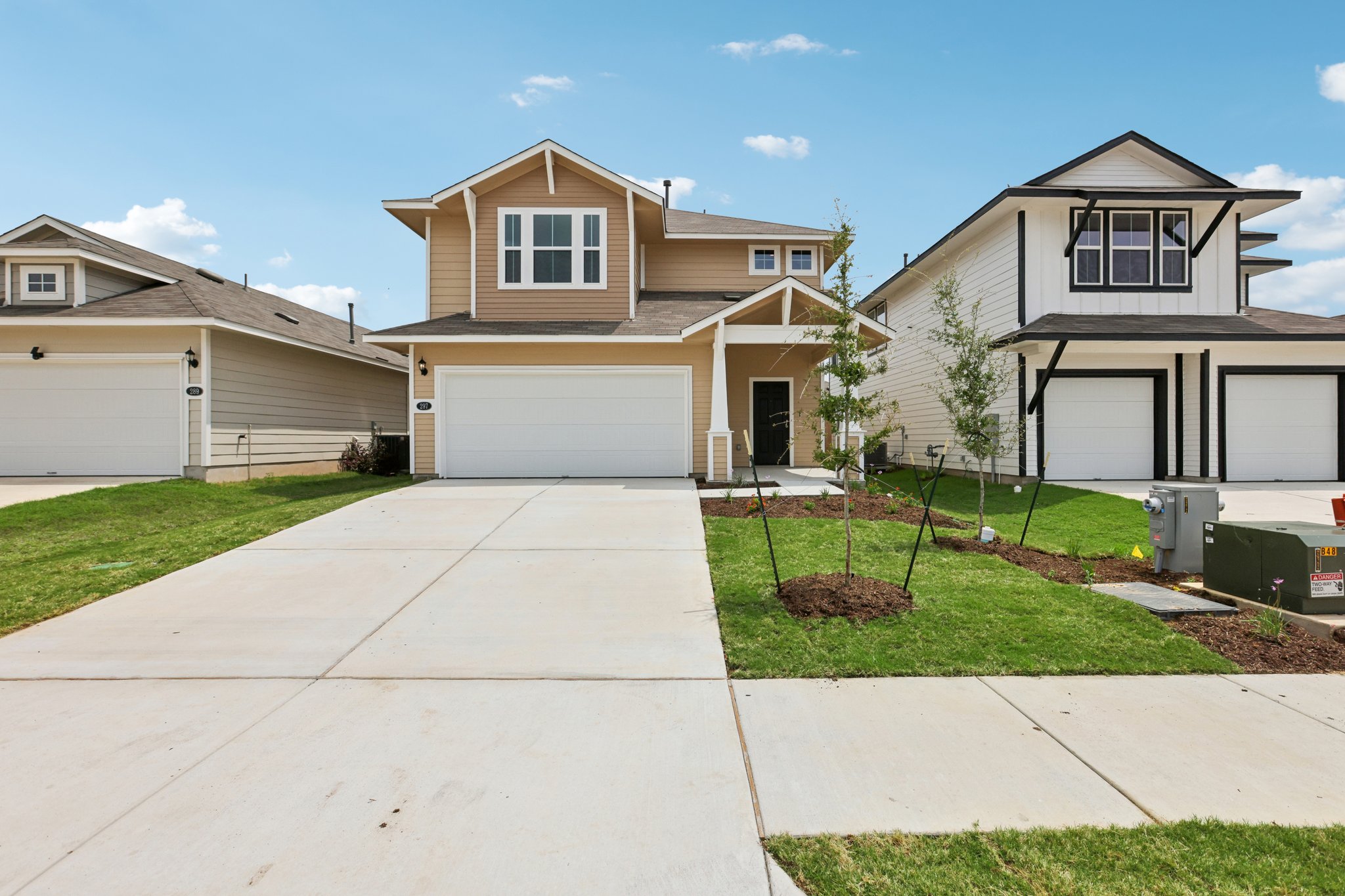 297 Jade Street Maxwell, TX 78656 - Photo 3 of 40 a front view of a house with a yard and garage