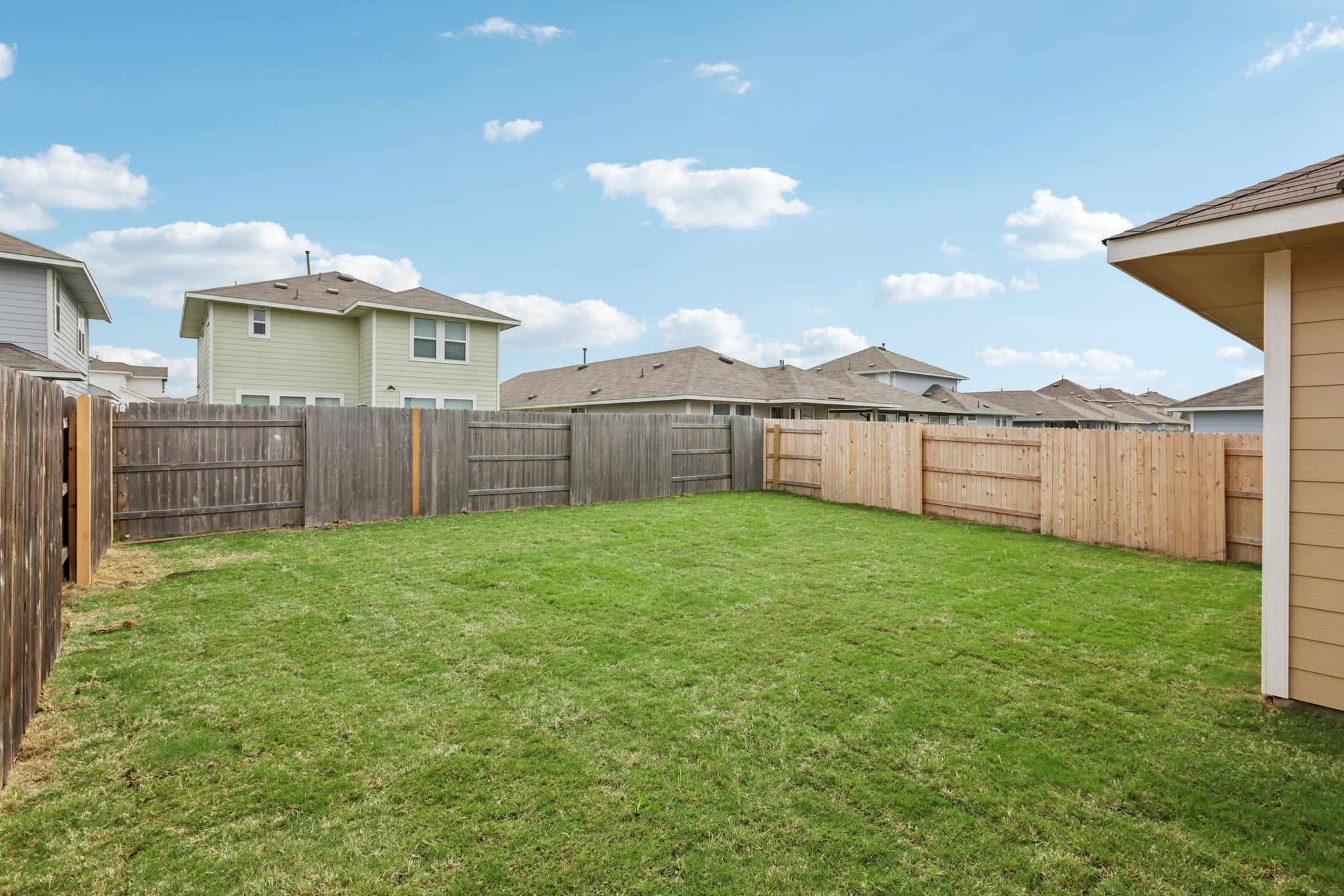 297 Jade Street Maxwell, TX 78656 - Photo 38 of 40 a view of a backyard with a garden and deck