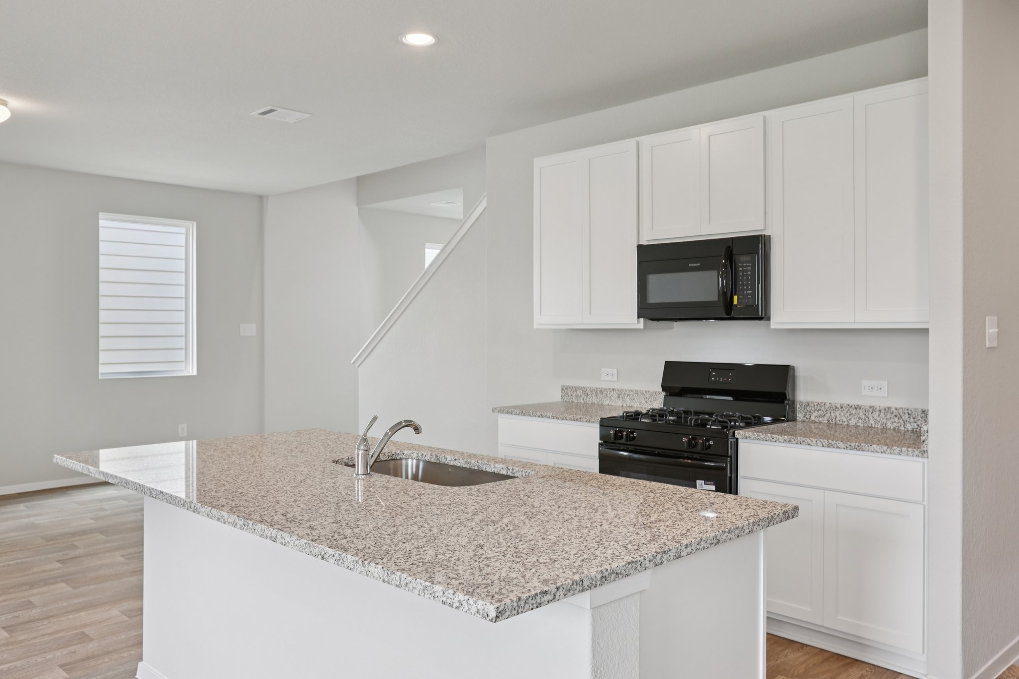 297 Jade Street Maxwell, TX 78656 - Photo 6 of 40 a kitchen with granite countertop a sink and a stove