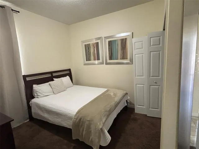 a bedroom with a bed and closet