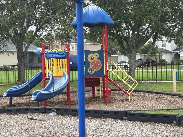 a view of swimming pool with lawn chairs and couches