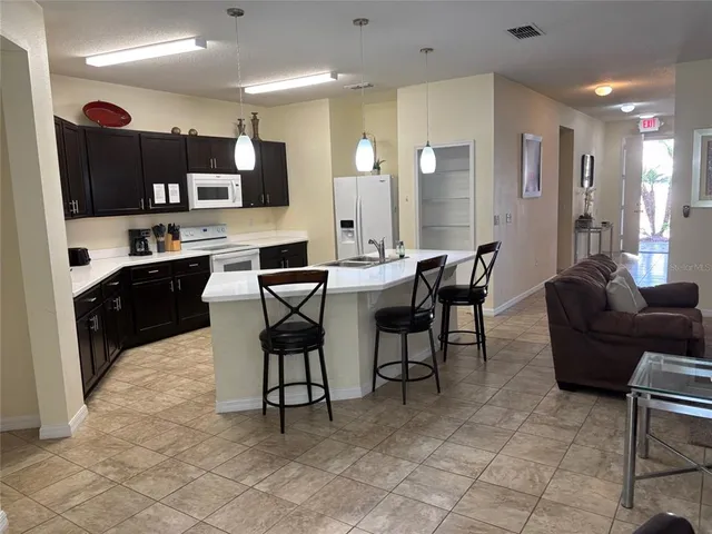 a large kitchen with a table and chairs