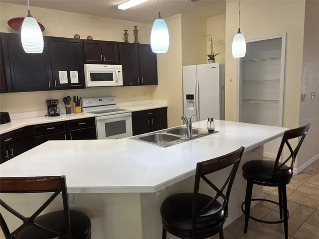 a kitchen with a dining table and chairs