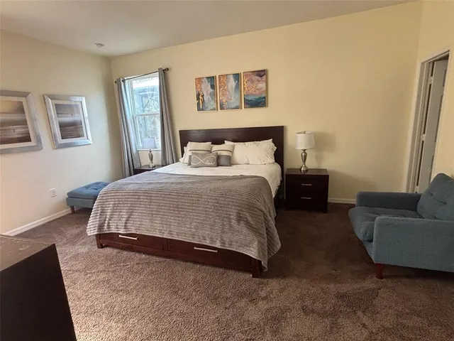 a bedroom with a bed and a couch