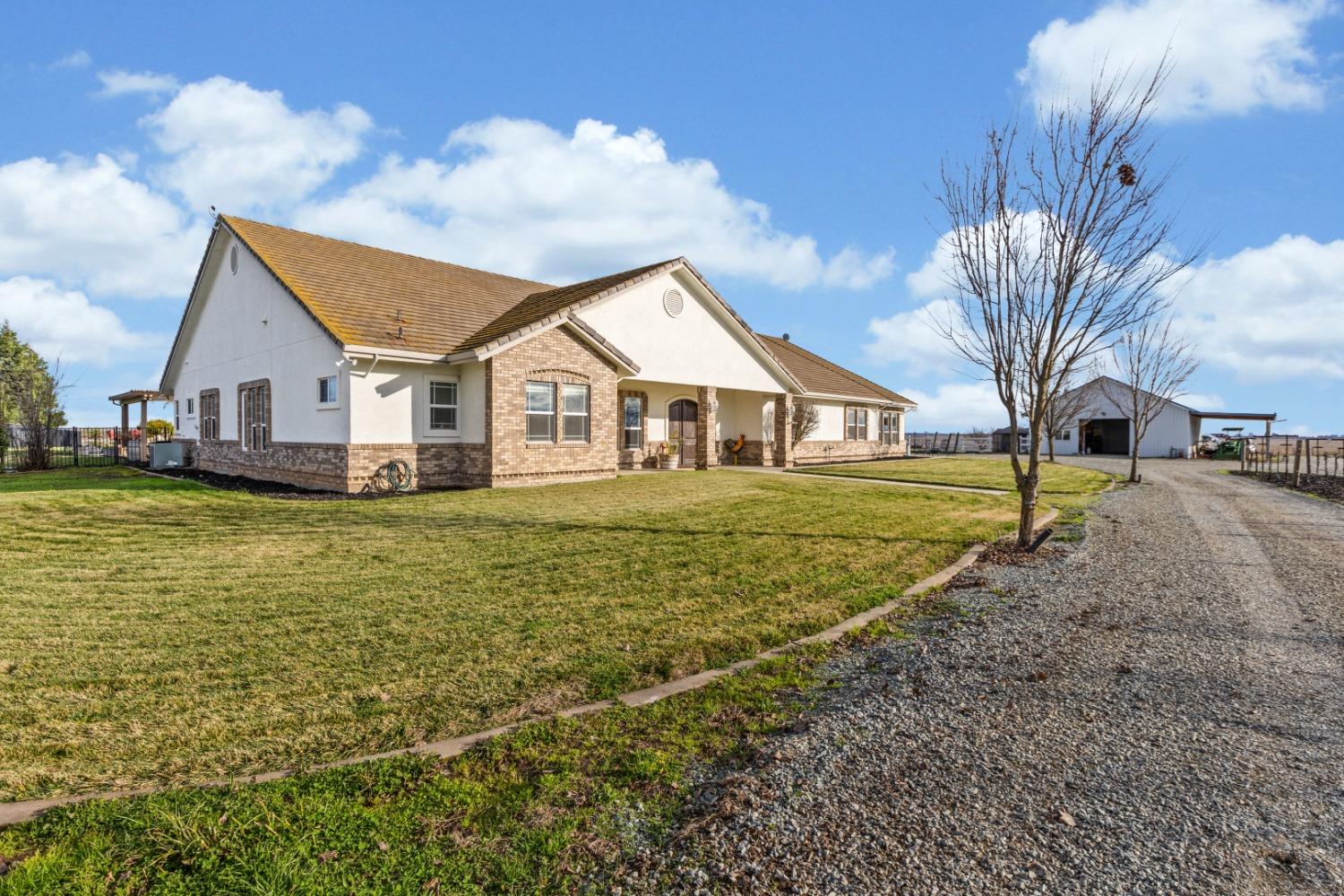 12500 Blake Road Wilton, CA 95693 - Photo 1 of 1 a view of a house with a big yard and large trees