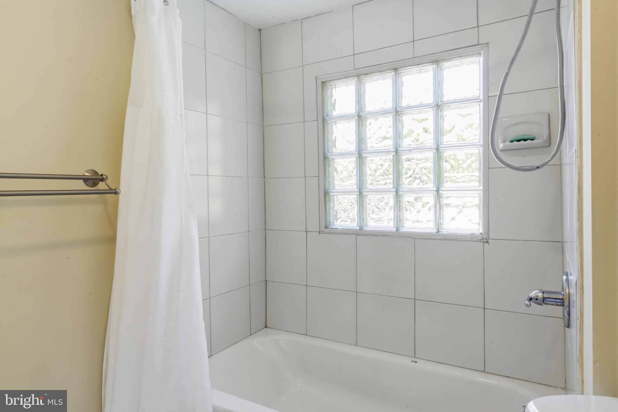 3700 Old Milford Mill Road Windsor Mill, MD 21244 - Photo 26 of 49 a bathroom with a bathtub and a shower