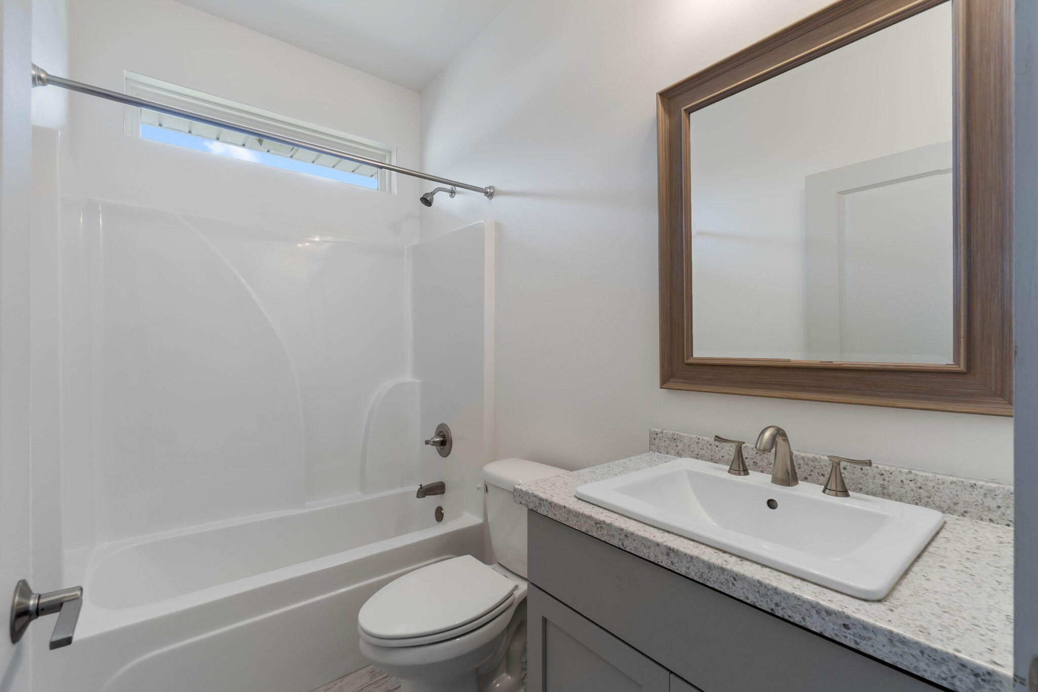 4464 Goldfinch Way Crestview, FL 32539 - Photo 14 of 31 a bathroom with a sink toilet and shower