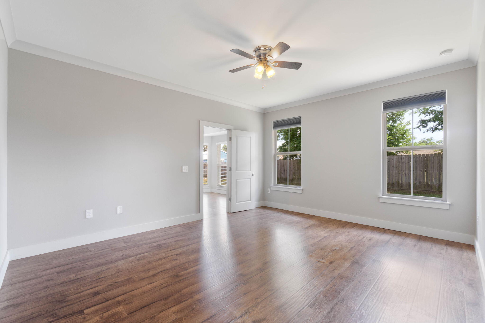 4464 Goldfinch Way Crestview, FL 32539 - Photo 20 of 31 a view of an empty room with wooden floor and a window