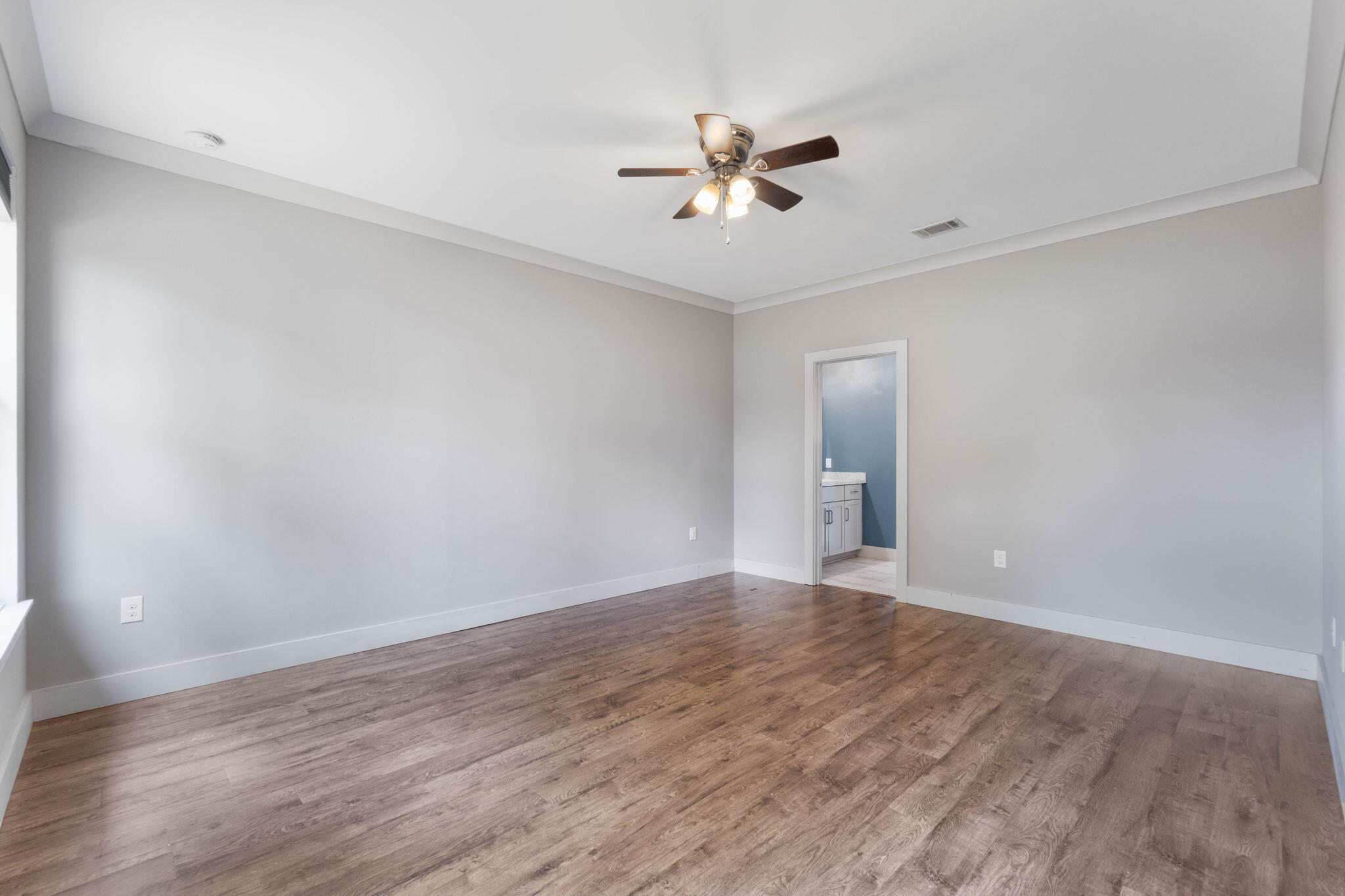 4464 Goldfinch Way Crestview, FL 32539 - Photo 21 of 31 a view of an empty room with chandelier fan and wooden floor
