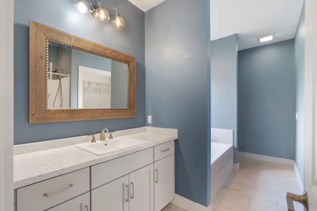 a bathroom with a sink vanity and a mirror