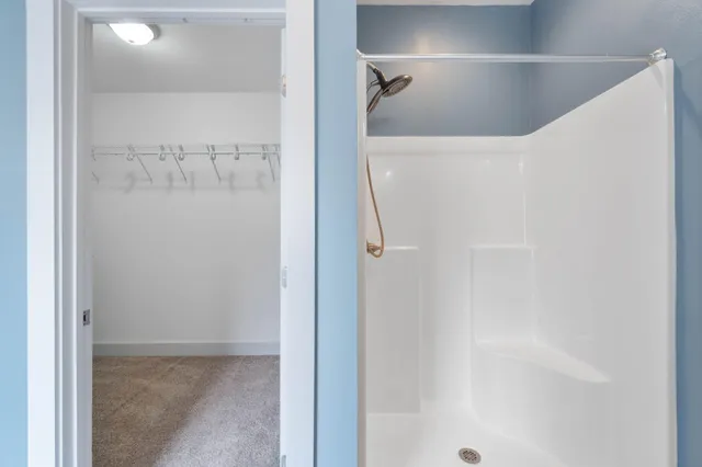 a bathroom with a glass shower door