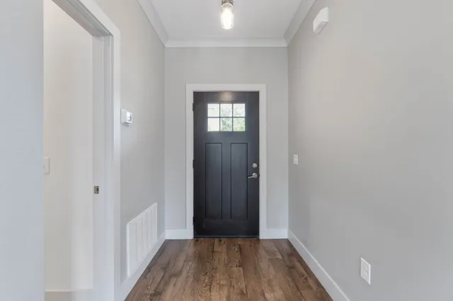 a view of a hallway with wooden floor