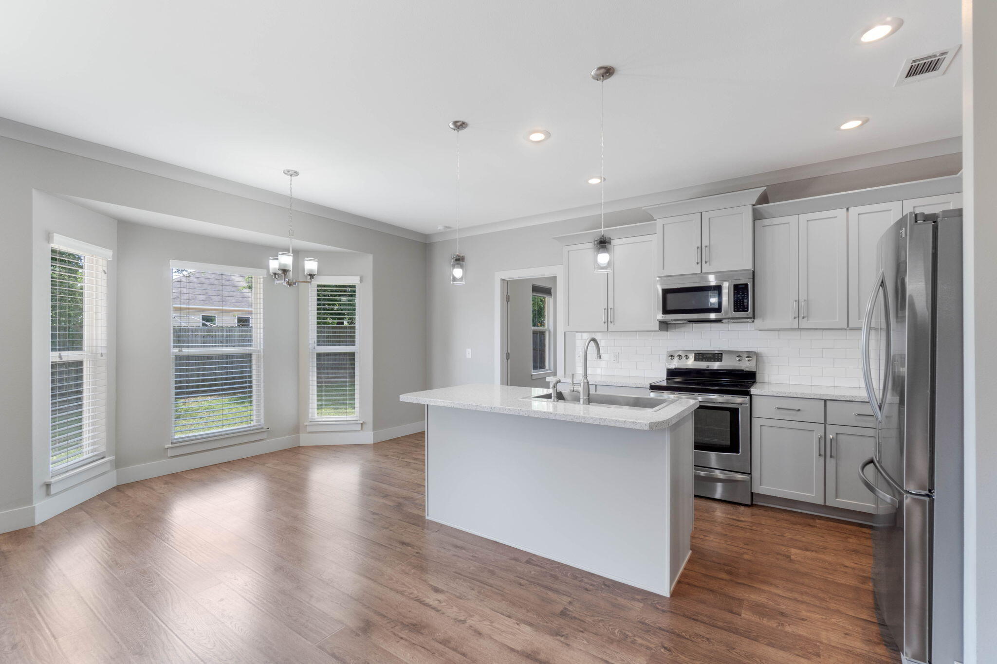 4464 Goldfinch Way Crestview, FL 32539 - Photo 6 of 31 a kitchen with stainless steel appliances a stove top oven and a refrigerator