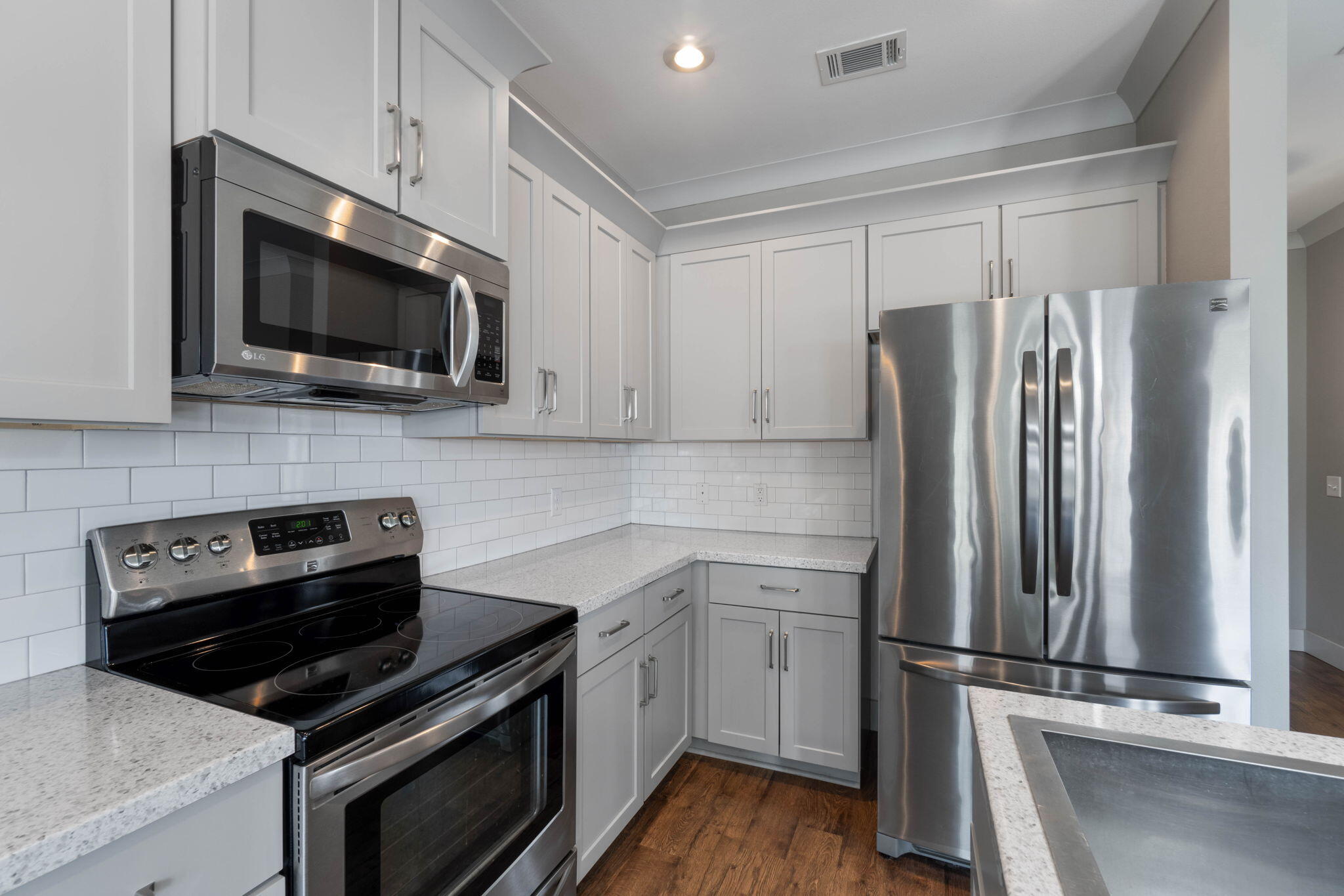 4464 Goldfinch Way Crestview, FL 32539 - Photo 9 of 31 a kitchen with a refrigerator stove and microwave