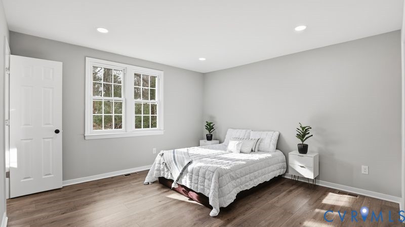 25209 Ritchie Avenue Petersburg, VA 23803 - Photo 30 of 50 a bedroom with a bed and wooden floor