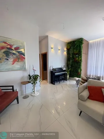 a lobby with furniture and flat screen tv