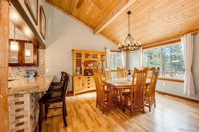 a dining room with furniture window and wooden floor