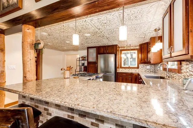 a kitchen with a stove a refrigerator and a sink