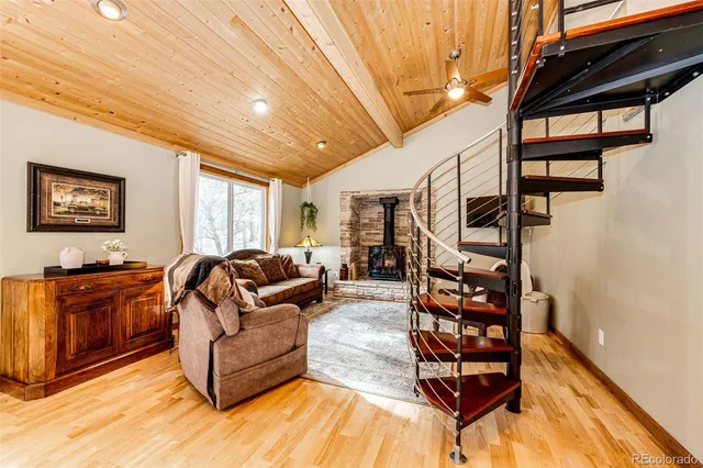a living room with furniture a rug and a window