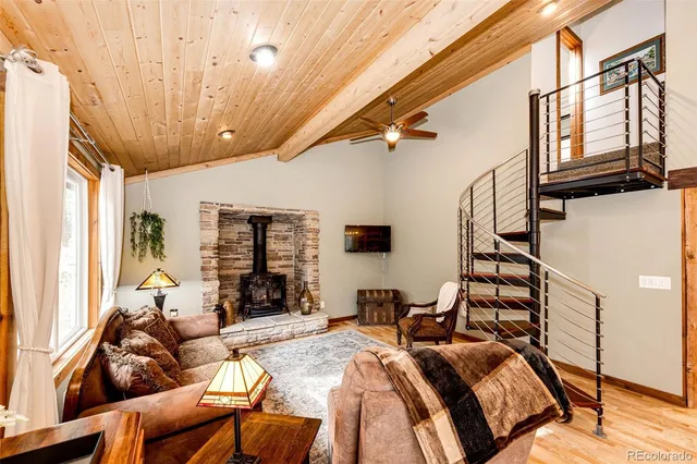 a bedroom with furniture wooden floor and window