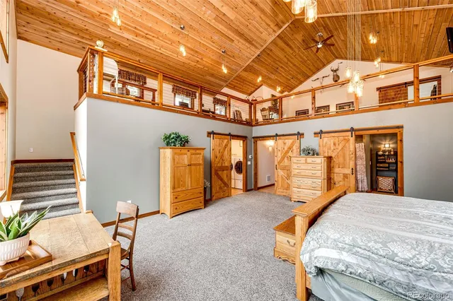 a bedroom with furniture and large windows