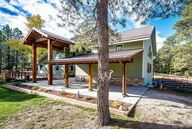 a view of a house with backyard porch and sitting area