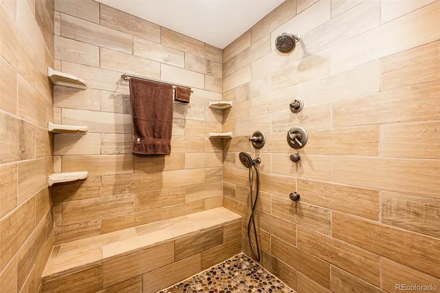 a bathroom with a bathtub and shower