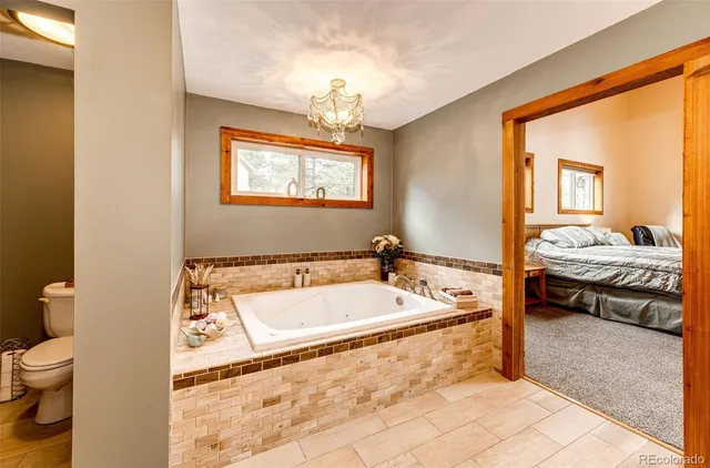 a spacious bathroom with a tub sink and toilet