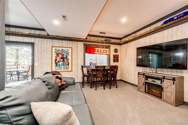 a dining room with furniture window and wooden floor