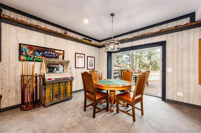 an outdoor living room with furniture and a flat screen tv