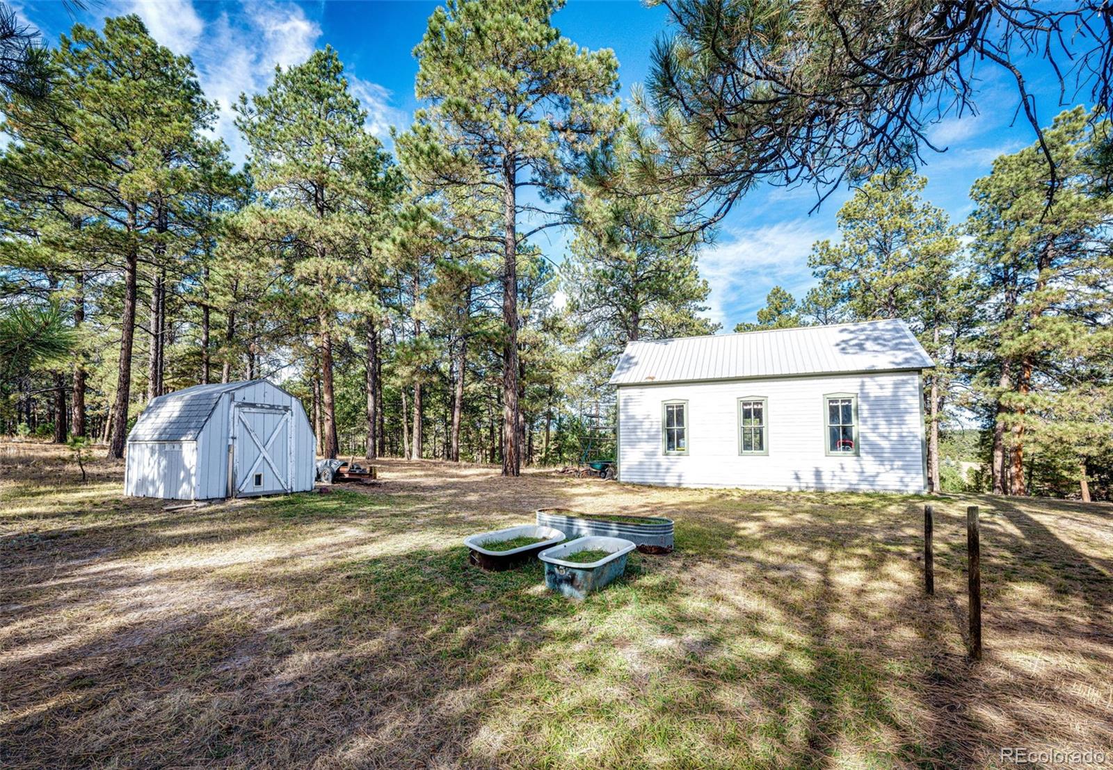 6412 County Road 82 Elbert, CO 80106 - Photo 5 of 50 a view of a house with a yard and wooden fence