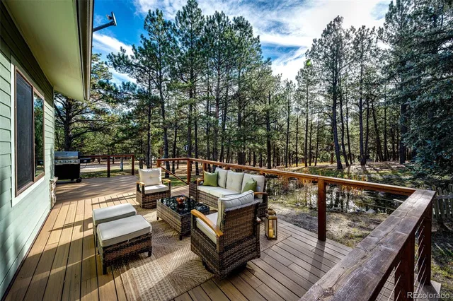 a view of deck with couches and wooden floor