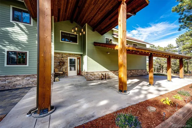a view of a porch with a table and chairs
