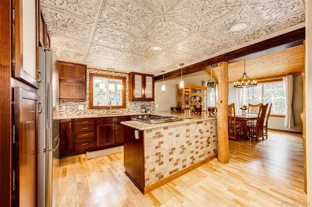 a large kitchen with stainless steel appliances granite countertop a stove and a refrigerator