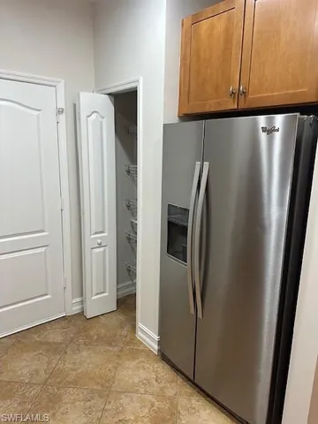 a room with pool table and windows