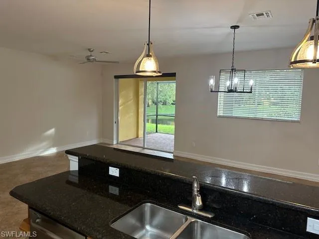 en empty room with windows and fan