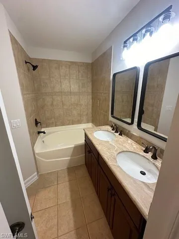 a bathroom with a sink a mirror and a washer