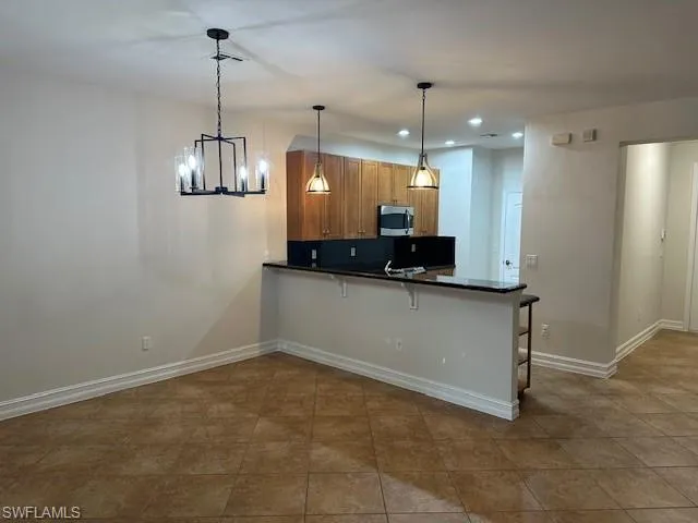a view of a kitchen with a sink and chandelier