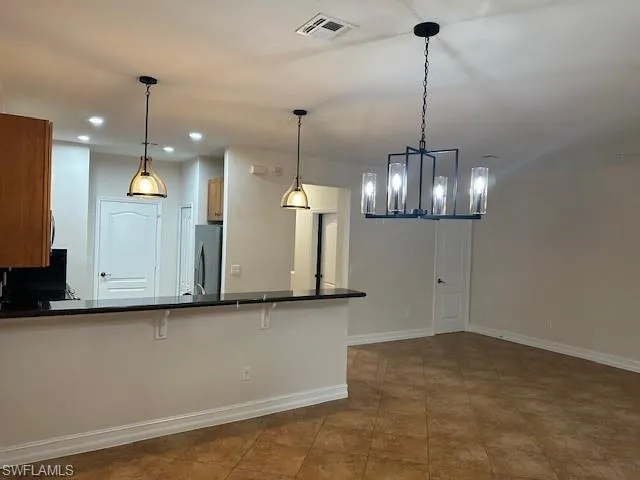 a view of a kitchen with a chandelier