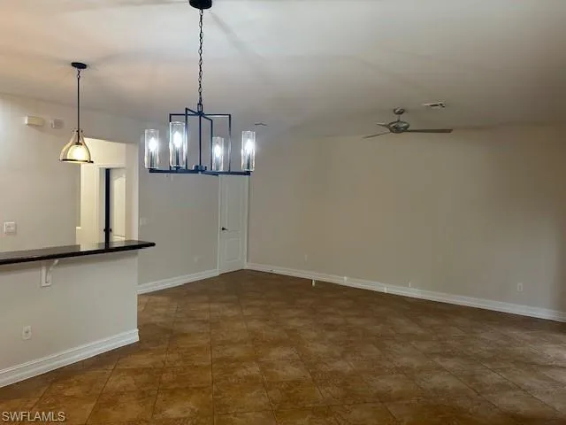 a view of empty room with wooden floor and ceiling fan