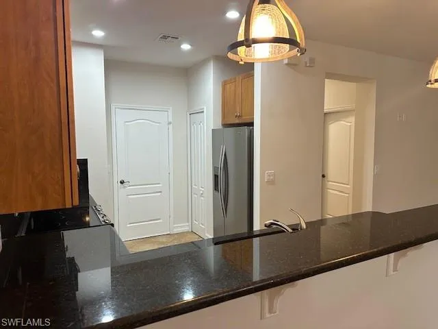 a view of a hallway and a living room with a mirror