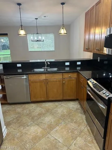 a large kitchen with cabinets and stainless steel appliances