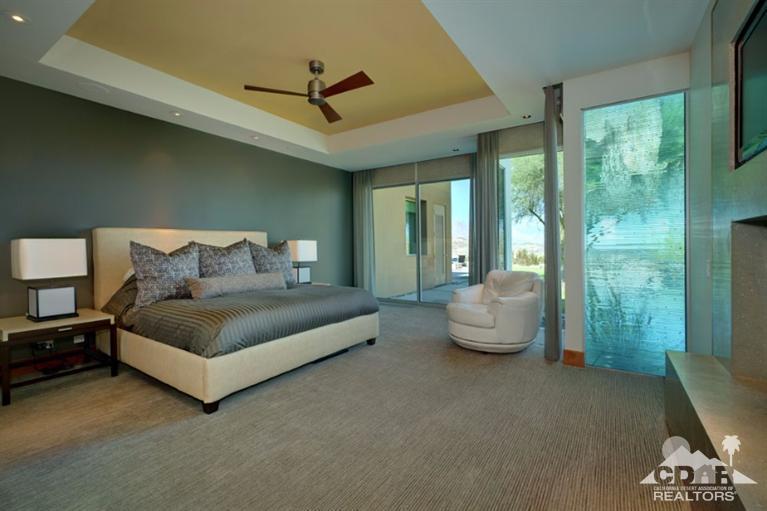10 Rockcrest Rancho Mirage, CA 92270 - Photo 26 of 32 a spacious bedroom with a bed and large windows