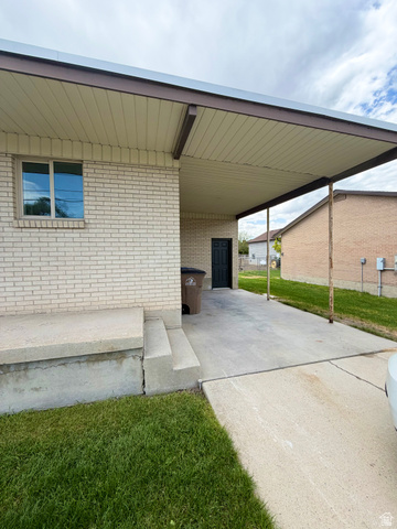 450 13800 South, Unit 2 Draper, UT 84020 - Photo 20 of 21 Carport with a light-colored soffit and brown trim, providing covered parking