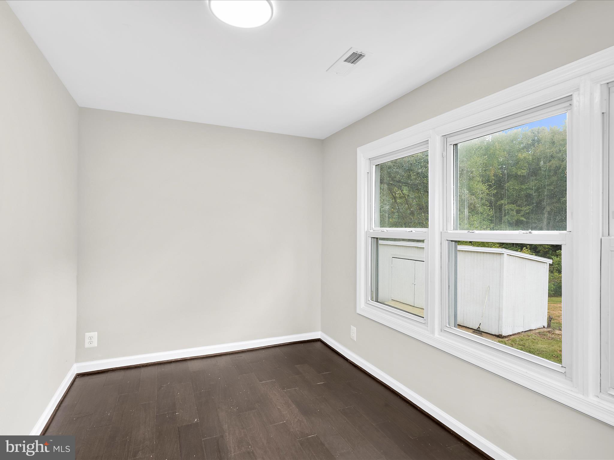 5660 New Cut Road Marbury, MD 20658 - Photo 12 of 38 a view of an empty room with a window and wooden floor