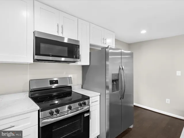 a kitchen with stainless steel appliances a stove a microwave and a counter top