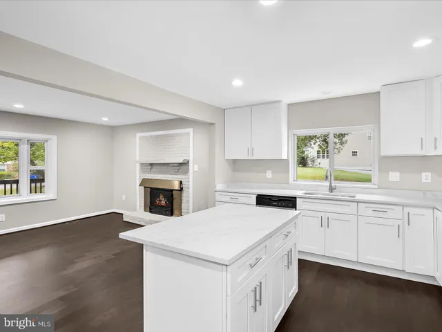 a kitchen with a stove sink and cabinets