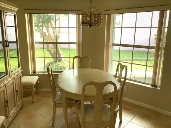 a dining room with furniture and window